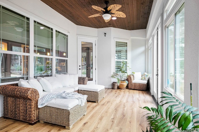 sunroom / solarium with ceiling fan, wooden ceiling, and a wealth of natural light