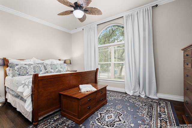 bedroom featuring ceiling fan, dark hardwood / wood-style flooring, and crown molding