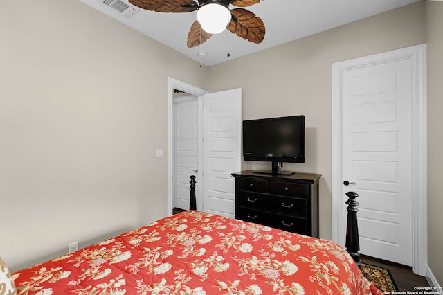 bedroom with ceiling fan and dark hardwood / wood-style floors