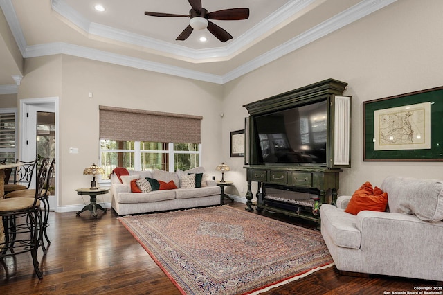 living room with ceiling fan, crown molding, dark hardwood / wood-style floors, and a tray ceiling