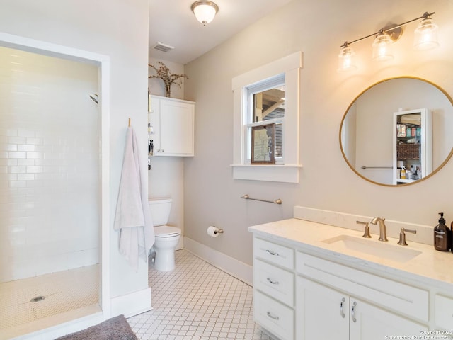 bathroom with tiled shower, vanity, toilet, and tile patterned flooring