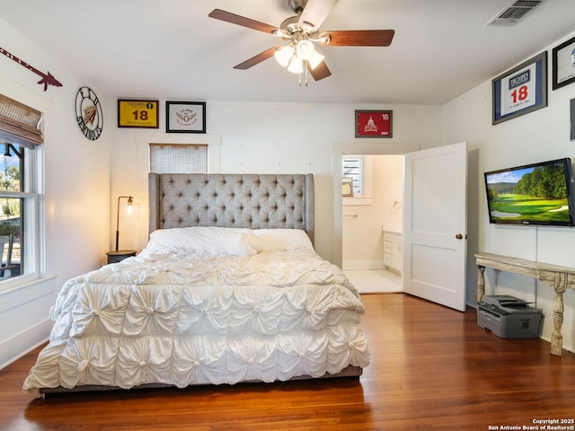 bedroom with ceiling fan, wood-type flooring, and connected bathroom