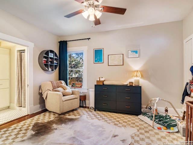 sitting room featuring ceiling fan