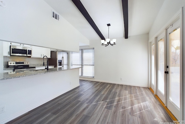 kitchen with stainless steel appliances, hanging light fixtures, beam ceiling, white cabinetry, and sink