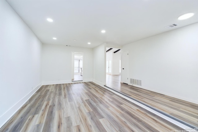 unfurnished room with light wood-type flooring