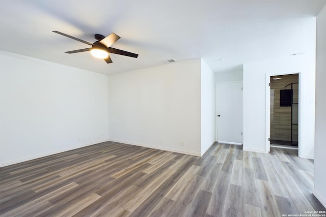 unfurnished room with ceiling fan and light hardwood / wood-style floors