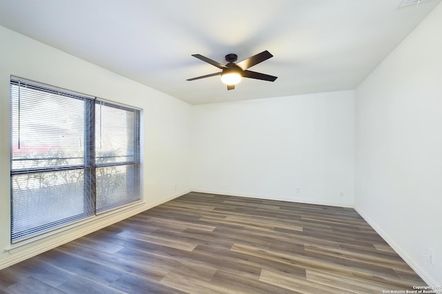 empty room featuring ceiling fan and dark hardwood / wood-style floors