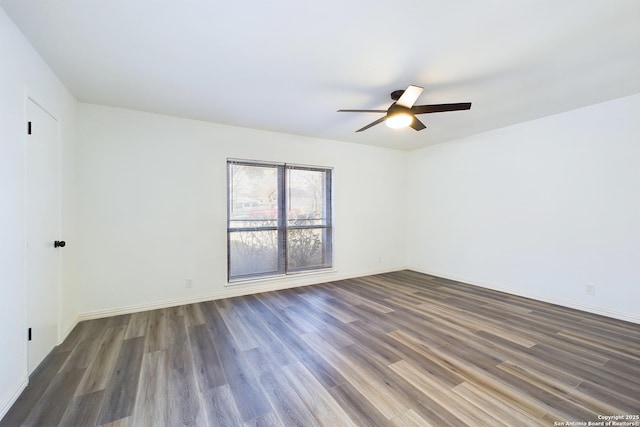 unfurnished room featuring ceiling fan and dark wood-type flooring