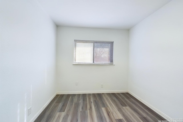 spare room featuring dark hardwood / wood-style flooring