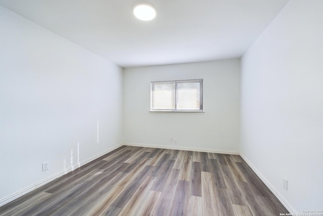 spare room with dark hardwood / wood-style flooring