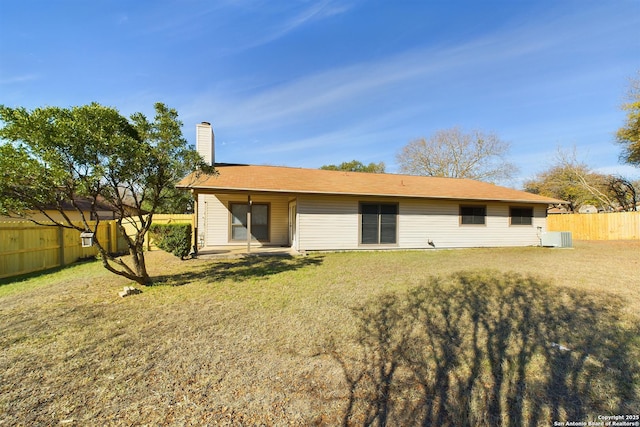 rear view of property featuring a yard