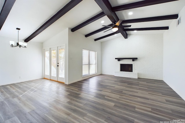 unfurnished living room with dark hardwood / wood-style flooring, french doors, a brick fireplace, and vaulted ceiling with beams