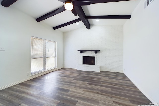 unfurnished living room with brick wall, a fireplace, ceiling fan, and dark wood-type flooring