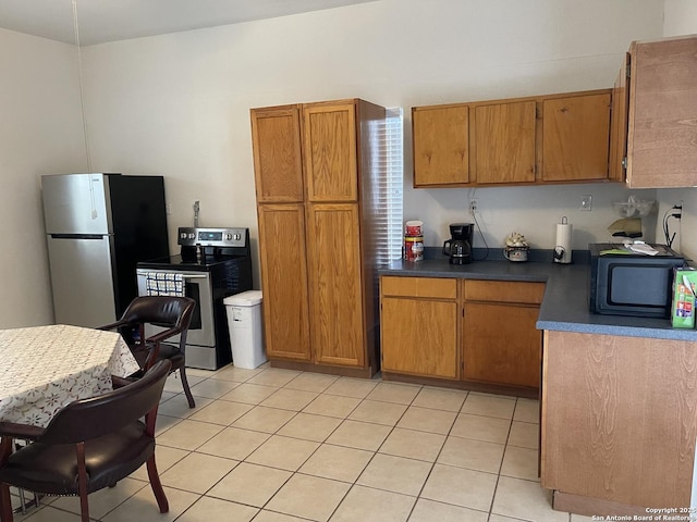 kitchen with stainless steel appliances and light tile patterned floors