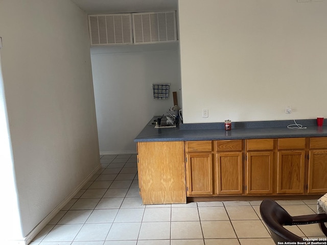 bar featuring light tile patterned floors