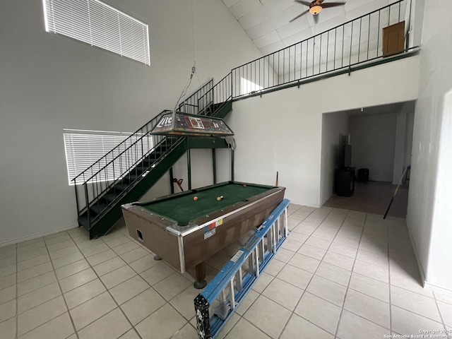 recreation room with a high ceiling, ceiling fan, light tile patterned flooring, and pool table