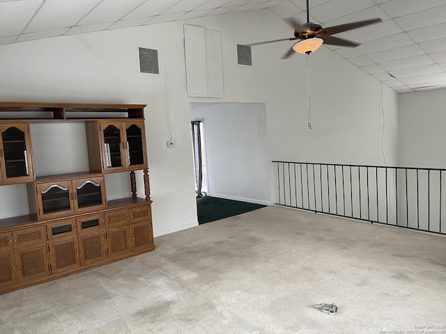 unfurnished living room with ceiling fan, vaulted ceiling, and light carpet