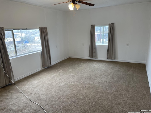 carpeted empty room featuring ceiling fan