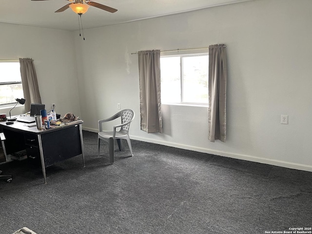 office space featuring dark carpet and ceiling fan