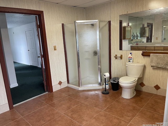 bathroom with walk in shower, tile patterned flooring, and toilet