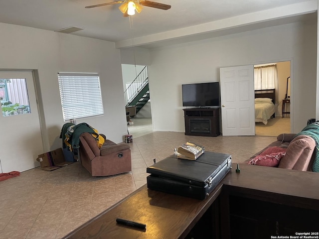 tiled living room featuring ceiling fan