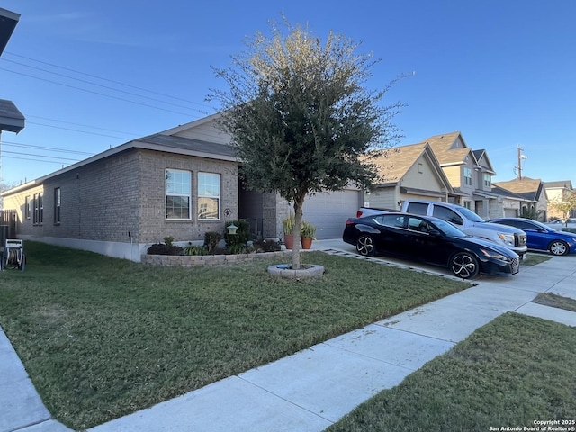 view of front of home with a garage and a front lawn