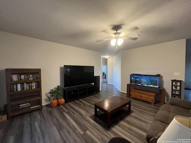 living room featuring hardwood / wood-style flooring, a textured ceiling, and ceiling fan