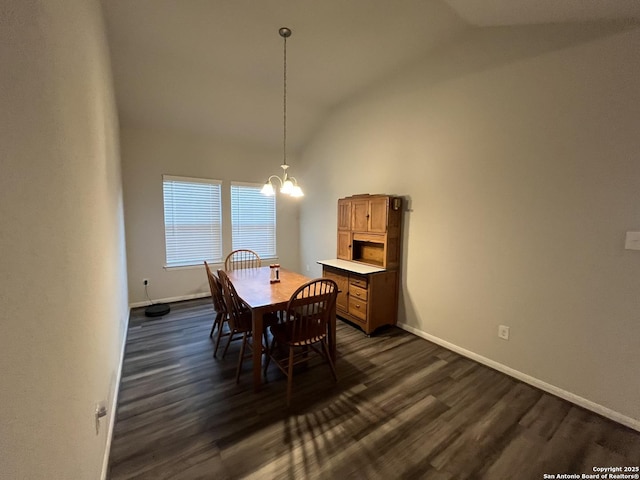 dining space featuring an inviting chandelier, vaulted ceiling, and dark hardwood / wood-style flooring