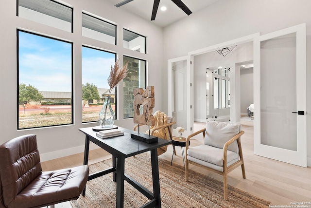 sitting room with french doors, ceiling fan, and light hardwood / wood-style floors