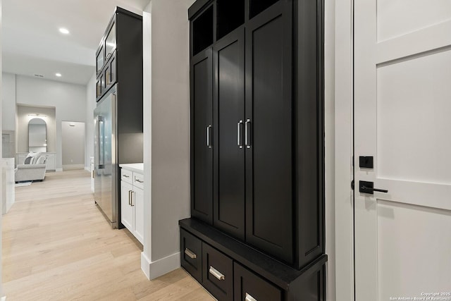 mudroom with light hardwood / wood-style floors