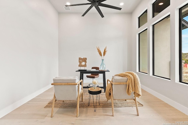 sitting room with ceiling fan and light hardwood / wood-style floors