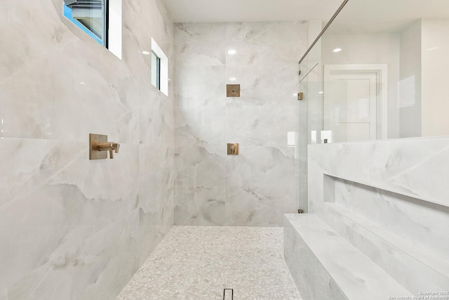 bathroom featuring a tile shower