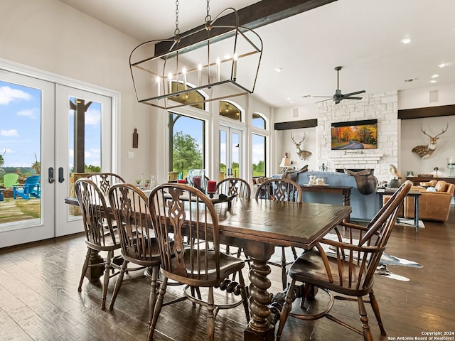 dining area with ceiling fan with notable chandelier, french doors, dark hardwood / wood-style flooring, and plenty of natural light