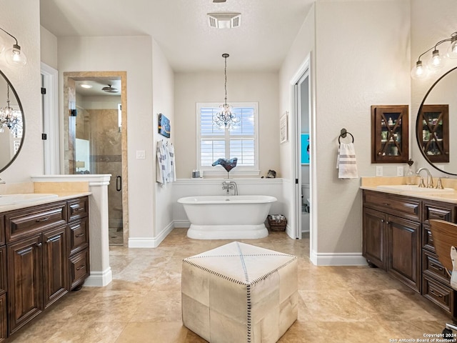 bathroom featuring an inviting chandelier, independent shower and bath, and vanity