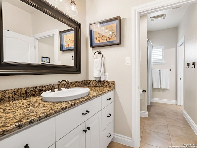 bathroom featuring tile patterned flooring and vanity