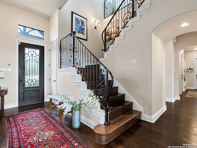 foyer with a high ceiling and hardwood / wood-style floors