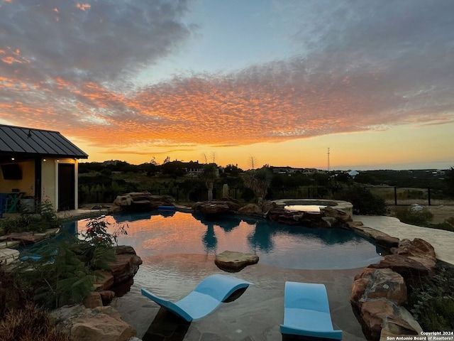 view of pool at dusk