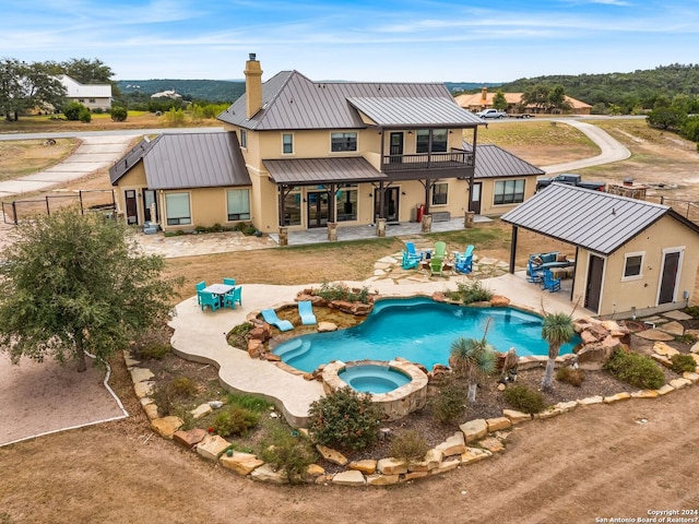 view of swimming pool with a patio area and an in ground hot tub