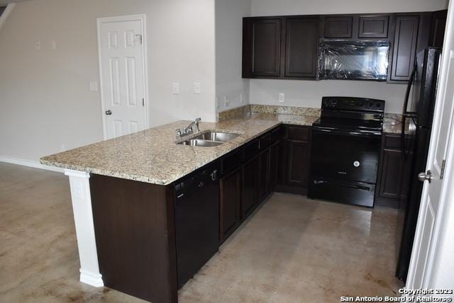 kitchen with kitchen peninsula, light stone countertops, sink, black appliances, and dark brown cabinetry