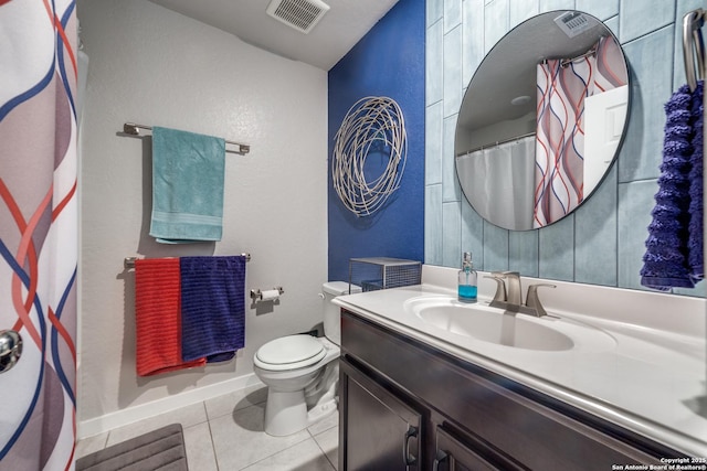 bathroom with toilet, tile patterned flooring, and vanity