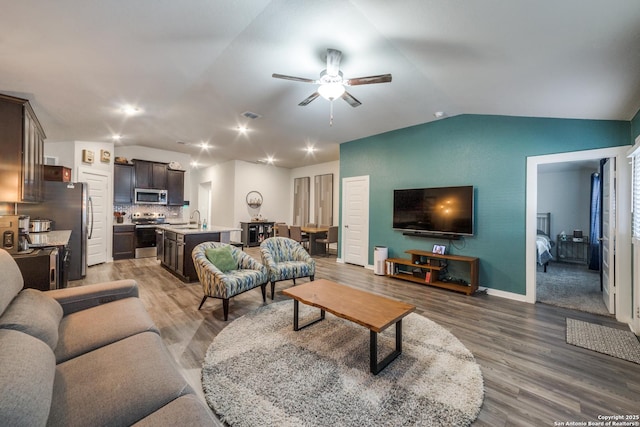 living room featuring sink, ceiling fan, lofted ceiling, and hardwood / wood-style flooring