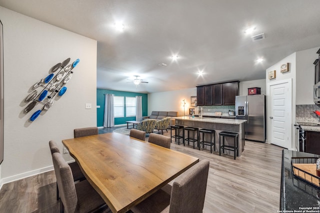 dining room with light wood-type flooring and ceiling fan