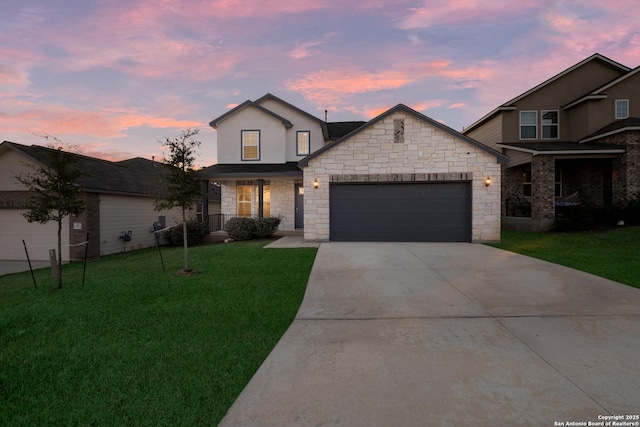 view of front facade with a garage and a yard