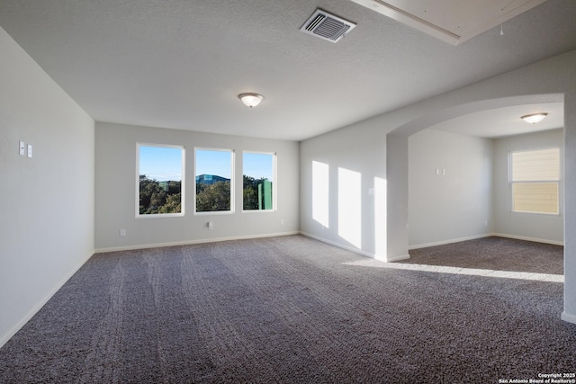 carpeted spare room with a textured ceiling