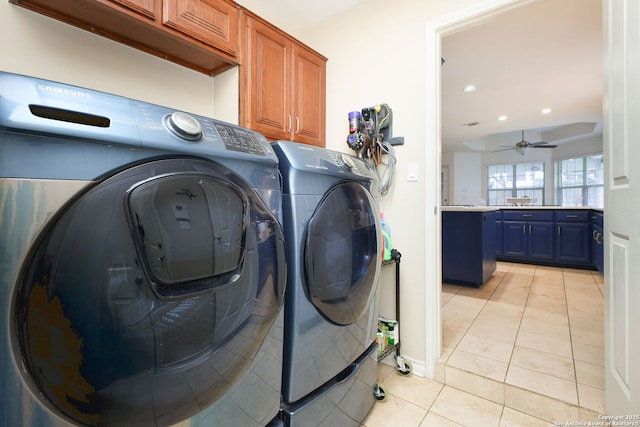 laundry area with ceiling fan, cabinets, independent washer and dryer, and light tile patterned floors