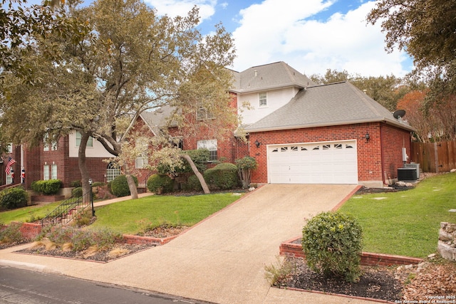 front of property featuring a front yard, a garage, and central air condition unit