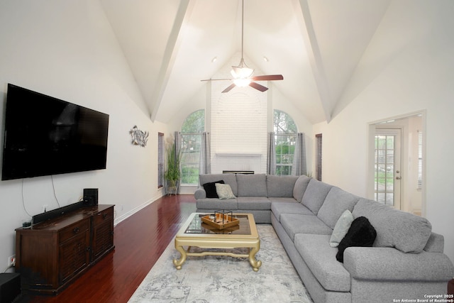 living room with lofted ceiling, dark wood-type flooring, and ceiling fan