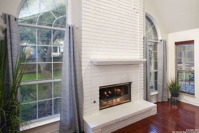 room details with wood-type flooring and a brick fireplace