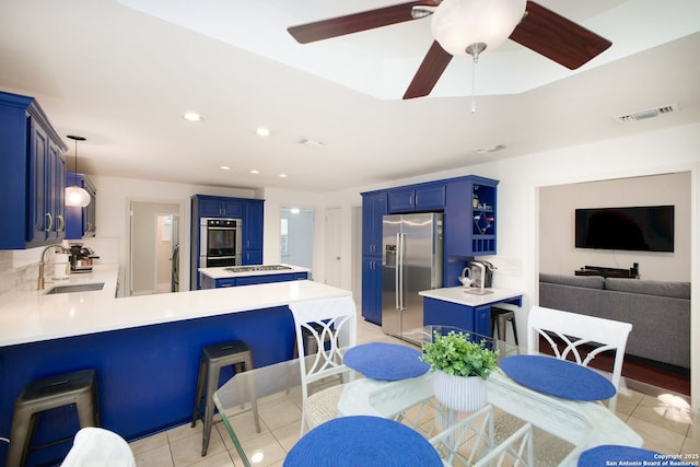 tiled dining area featuring sink and ceiling fan