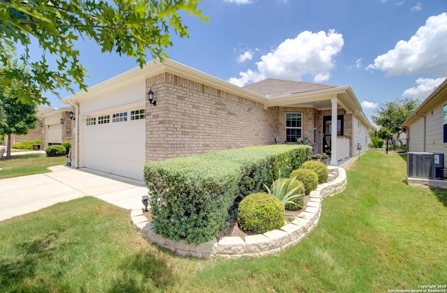 ranch-style house with central AC, a front lawn, and a garage